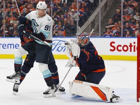 Edmonton Oilers goaltender Stuart Skinner makes a glove save while Seattle Kraken forward Andre Burakovsky looks for a rebound during the second period at Rogers Place.