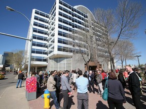 Workers stand outside the John E. Brownlee Building, where Alberta Justice is based, at 10365-97 St., on May 11, 2015.