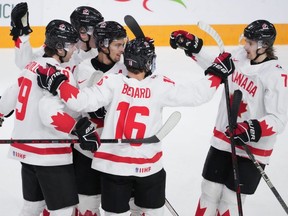 Canada's Dylan Guenther, centre, celebrates his power play goal with teammates during first period IIHF World Junior Hockey Championship gold medal action against Czechia in Halifax, Thursday, Jan. 5, 2023.