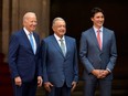 Mexican President Andres Manuel Lopez Obrador (C) stands next to U.S. President Joe Biden (L) and Canada's Prime Minister Justin Trudeau, in Mexico City, on January 10, 2023 at the Three Amigos Summit