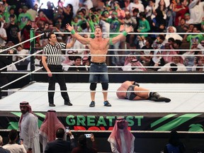 John Cena celebrates defeating Triple H during the World Wrestling Entertainment Greatest Royal Rumble event in the Saudi coastal city of Jeddah on April 27, 2018. Calgary writer Rahim Mohamed cites pro wrestling as an analogy for the political tussle between Premier Danielle Smith and Prime Minister Justin Trudeau over the "just transition."