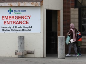People head into the emergency entrance for the University of Alberta Hospital and Stollery Children's Hospital, in Edmonton Wednesday May 11, 2022.