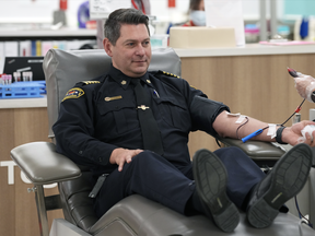 Edmonton Fire Rescue Services Chief Joe Zatylny donates blood in Edmonton on Tuesday, Jan. 3, 2023. Emergency service workers in Edmonton are answering the call to help save lives as part of a month-long Sirens for Life campaign organized by Canadian Blood Services.