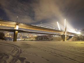 Lights from the Tawatinâ LRT Bridge illuminate the fog over the bridge on Monday, Jan. 9, 2023 in Edmonton.