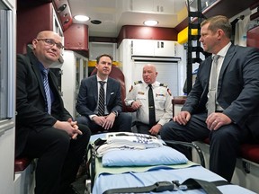 Health Minister Jason Copping, second from left, provided an update to work being done to improve the province's emergency medical services at the Spruce Grove Protective Services Building in Spruce Grove on Monday, Jan. 16, 2023. He was inside an ambulance with Spruce Grove/Stony Plain UCP MLA Searle Turton, left, parliamentary secretary for EMS reforms RJ Sigurdson, right, and assistant deputy chief, EMS, Spruce Grove Fire Services Cory Klebanosky.