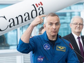Former astronaut and MP Marc Garneau, right, looks on as Astronaut David Saint-Jacques speaks during a government of Canada announcement supporting commercial space launches, at the Canadian Space Agency in Longueuil, Que., Friday, January 20, 2023.