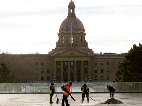 Crews clear snow in the Violet King Henry Plaza at the Alberta Legislature in Edmonton, Tuesday, Jan. 24, 2023.