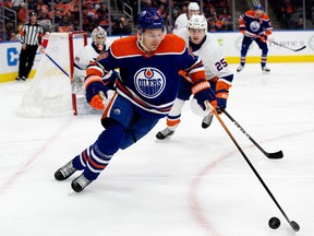 The Edmonton Oilers' Zach Hyman (18) battles the New York Islanders' Sebastian Aho (25) during first period NHL action at Rogers Place, in Edmonton Thursday Jan. 5, 2023. Photo By David Bloom