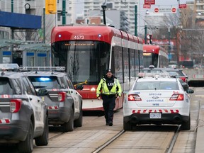 Police cars surround a TTC streetcar on Spadina Ave., in Toronto on Tuesday, January 24, 2023 after a stabbing incident. The&ampnbsp;Toronto mayor and police chief along with the head of the city's transit operator are set to hold a press conference on transit safety after several violent incidents on the system recently.&ampnbsp;THE CANADIAN PRESS/Arlyn McAdorey