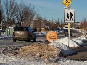 Traffic makes its way along a snow covered road in Edmonton, Monday Nov. 14, 2022.