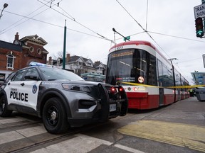 Police cars surround a TTC streetcar on Spadina Ave., in Toronto on Tuesday, January 24, 2023 after a stabbing incident. The president of a Canadian transit union wants to convene a national task force as violent attacks on public transit reach what he calls "crisis levels."