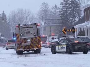 Police and fire officials block off a road as municipal officials say workers are missing after an explosion at a propane facility in St-Roch-de-l'Achigan, Que., north of Montreal on Thursday, Jan.12, 2023.&ampnbsp;A man who witnessed the explosion at a Quebec propane distribution company north of Montreal rushed to the site and attempted to save a woman in distress.THE&ampnbsp;CANADIAN PRESS/Ryan Remiorz