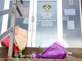 Flowers are placed at the entrance to OPP detachment in Cayuga, where Const. Grzegorz (Greg) Pierzchala worked. He was shot and killed Tuesday.