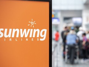 Travellers wait in line at a Sunwing Airlines check-in desk at Trudeau Airport in Montreal on Wednesday, April 20, 2022. Travel agents in Saskatchewan say they could be out thousands of dollars after Sunwing cancelled flights from the Saskatoon and Regina airports for the month.