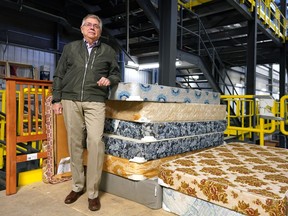 John Shalewa, president of Ukrainian Canadian Social Services, with some donated beds in Edmonton on  Tuesday, Jan. 17, 2023. His organization has teamed up with the Ukrainian Canadian Congress-Alberta Provincial Council and Catholic Social Services to supply beds in support of families in the Edmonton area who fled the war in Ukraine.