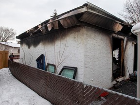 Police investigate the scene of a garage fire  on Sunday, Jan. 22, 2023, in Edmonton.