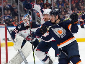 Dylan Holloway (55) of the Edmonton Oilers, tries to get past Vladislav Gavrikov (4) of the Columbus Blue Jackets in the first period at Rogers Place in Edmonton, on January 25, 2023.