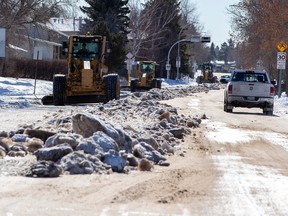 Graders continue to clear windrows of snow from the sides of streets in the east end on Friday, Feb. 25, 2022 in Edmonton.