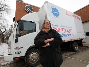 Society of Saint Vincent de Paul's Lorraine Turchansky poses for a photo with one of the organization's trucks, in Edmonton Friday Jan. 13, 2023. Members of the Edmonton Society of Saint Vincent de Paul, a charity that provides food, furniture and household items to people in serious need, fear they are being targeted following the vandalism and theft of two of their trucks.