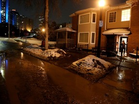 Karen Lynch looks on from the flooding outside her home near Rossdale Road and 102 Street on Monday January 30, 2023.