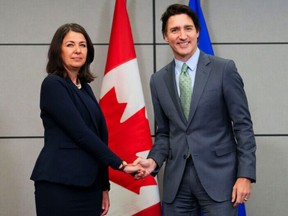 Prime Minister Justin Trudeau meets with Alberta Premier Danielle Smith as Canada's premiers meet in Ottawa on Tuesday, Feb. 7, 2023 in Ottawa. Alberta Premier Danielle Smith has met face to face with Prime Minister Justin Trudeau in a photo opportunity punctuated by short statements and a very awkward handshake.