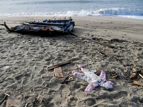 A photograph taken on February 28, 2023 shows a onesie and pieces of wood washed up on the beach, two days after a boat of migrants sank off Italy's southern Calabria region, in Steccato di Cutro, south of Crotone.