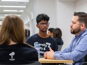 Grade 12 student Abinash Saravanan listens to Coun. Michael Janz as more than 150 students from five  schools that are taking part in an anti-racism summit series to listen, learn and be inspired at the Stanley A. Milner Library on Wednesday, Feb. 15, 2023 in Edmonton.