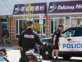 Police patrol the downtown Edmonton Chinatown district on Thursday May 26, 2022 after two recent random murders in the area.