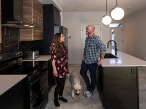Courtney and Tim Hinschberger with their dog Lilly, love their new home in Cantiro Homes at Castlebrook.