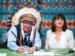 Chief Desmond Bull and assistant deputy minister for Indigenous Services Canada, Catherine Lapp, sign a bilateral agreement between Louis Bull Tribe and the Government of Canada to support Bill C-92, in Maskwacis, south of Edmonton on Wednesday Feb. 1, 2023. The historic agreement enables the First Nation to administer jurisdiction over its own child and family services.