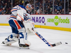 Edmonton Oilers goalie Stuart Skinner (74) handles the puck against the Vancouver Canucks in the third period at Rogers Arena on Jan 21, 2023. Oilers won 4-2.