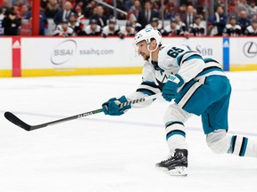 San Jose Sharks defenceman Erik Karlsson (65) shoots the puck against the Washington Capitals in the second period at Capital One Arena on Feb. 12, 2023.