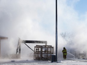 Firefighters work at the scene of house fire at 223 and 235 Glenridding Ravine Road SW in Edmonton, Friday, Feb. 24, 2023. Photo By David Bloom