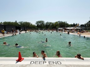 Edmontonians take the edge off afternoon heat with a swim at Borden Natural Swimming Pool in Edmonton, on Wednesday, July 11, 2018. The pool uses naturally occurring filtration processes to clean the water including layers of rock, two regeneration basins filled with plant and animal life, and the sun's UV rays.