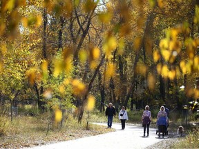 Walkers, bikers and hikers enjoy fine fall weather on a pathway in southeast Calgary, in the Douglasdale community on Sunday, September 25, 2022. If we all paid more attention to our activity levels, we'd be better off personally and as a society, writes Penny Werthner, former dean of the University of Calgary's faculty of kinesiology.