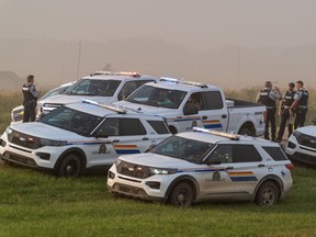 Police and investigators are seen at the side of the road outside Rosthern, Sask., on Wednesday, Sept. 7, 2022. RCMP say Myles Sanderson, a suspect in a deadly stabbing rampage northeast of Saskatoon over the weekend, has been taken into custody near the town of Rosthern on the fourth day of a massive manhunt. Inquests examining the Saskatchewan stabbing rampage that left 11 people dead and 18 injured are tentatively scheduled to take place early next year.