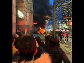 Photos from social media show flames shooting up from the ground outside the Marine Building on Burrard Street near West Hastings Street.