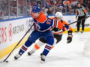 Philadelphia Flyers' Ivan Provorov (9) chases Edmonton Oilers' Connor McDavid (97) during second period NHL action in Edmonton on Tuesday February 21, 2023. McDavid, Boston Bruins goaltender Linus Ullmark and Anaheim Ducks goaltender John Gibson have been named the NHL three stars of the week.THE CANADIAN PRESS/Jason Franson
