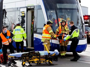 Emergency crews respond to a mannequin patient as TransEd conducts a test case scenario with emergency services personnel involving the Valley Line LRT at the 75 Street and 51 Avenue intersection on Thursday, Feb. 16, 2023. The live scenario was to simulate an emergency situation between a train and a cyclist, while practicing coordination between TransEd and emergency services who would be involved in a real-life incident.