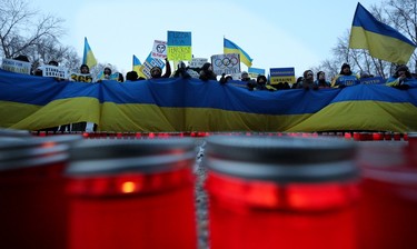 Edmontonians mark the one-year anniversary of Russia's full-scale invasion of Ukraine with a vigil outside the Alberta Legislature in Edmonton, Friday Feb. 24, 2023.