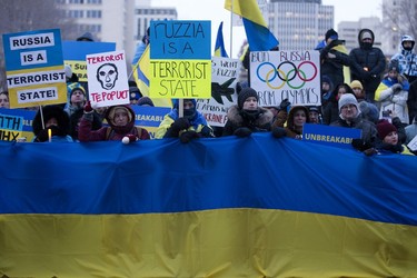 Edmontonians mark the one-year anniversary of Russia's full-scale invasion of Ukraine with a vigil outside the Alberta Legislature in Edmonton, Friday Feb. 24, 2023.