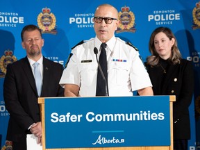 Public Safety and Emergency Services Minister Mike Ellis, left, listens with Coun. Sarah Hamilton, right, as Alberta Sheriffs Chief Farooq Sheikh talks on Wednesday, Feb. 1, 2023, about a 15-week pilot partnership between the Alberta Sheriffs and the Edmonton Police Service which will begin in late February to help deter and respond to crime and social disorder.