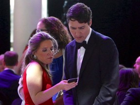 Prime Minister Justin Trudeau confers with his chief of staff Katie Telford at the National Press Gallery Dinner in Gatineau, Quebec, Saturday June 3, 2017.