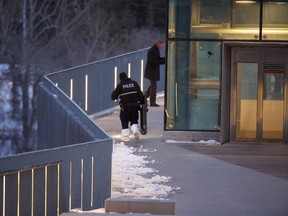 Edmonton police officers investigate the scene of a reported officer-involved shooting on the funicular promenade bridge leading to the Frederick G. Todd Lookout on Thursday, March 2, 2023.