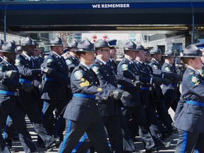 Police and Peace officers march down 104 Ave In Edmonton and up 102 Street into Rogers Place on March 27, 2023. The regimental funeral was for Edmonton Police Service constables Travis Jordan and Brett Ryan killed in the line of duty.