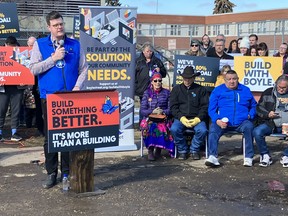 Jordan Reiniger, executive director of Boyle Street Community Services, addresses a crowd outside okimaw peyesew kamik, the future home of Boyle Street Community Service also known as King Thunderbird Centre at 101 Street and 107A Avenue, on March 21, 2023. The City of Edmonton reissued a development permit for the building, revoked by a city tribunal in November, to continue with the project.