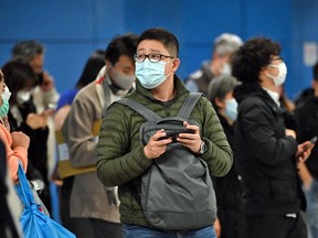 People wear masks on the Mass Transit Railway system in Hong Kong on February 27, 2023. On March 1 they the COVID restriction forcing them to wear masks in public was finally dropped.