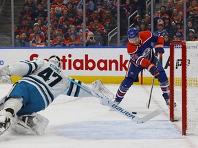 Oilers forward Nick Bjugstad (72) scores a goal during the first period against San Jose Sharks goaltender James Reimer at Rogers Place on Monday night.