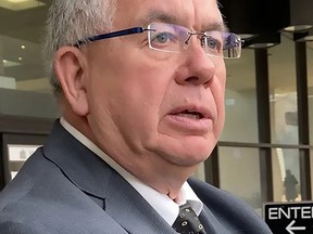 Lionel Chartrand discusses a case outside the Edmonton Law Courts in April 2022.
