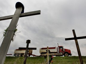 A truck passes a  memorial for victims of a crash on Highway 28 north of Gibbons. File photo.
